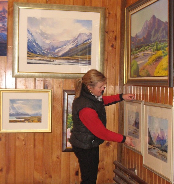 Emily Murray hanging paintings